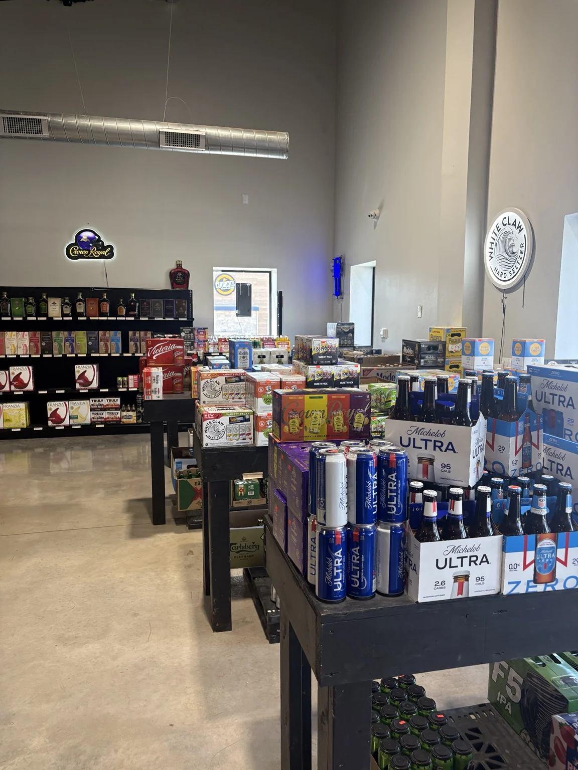 Beer packs and canned drinks displayed inside the store