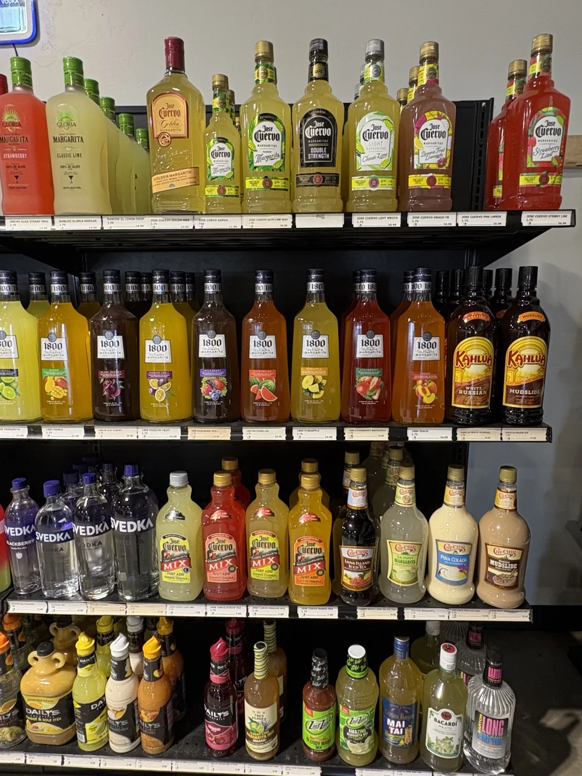 Bacardí and Cruzan rum above bottled cocktail mixes, Kahlúa and other mixers at One Stop Liquor in Bethany, Oklahoma