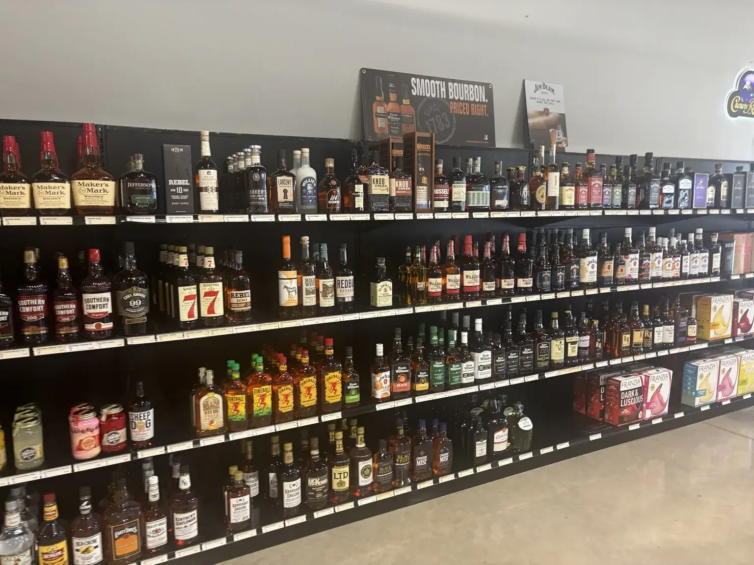 Bourbon and whiskey bottles on wall shelves at One Stop Liquor in Bethany, Oklahoma