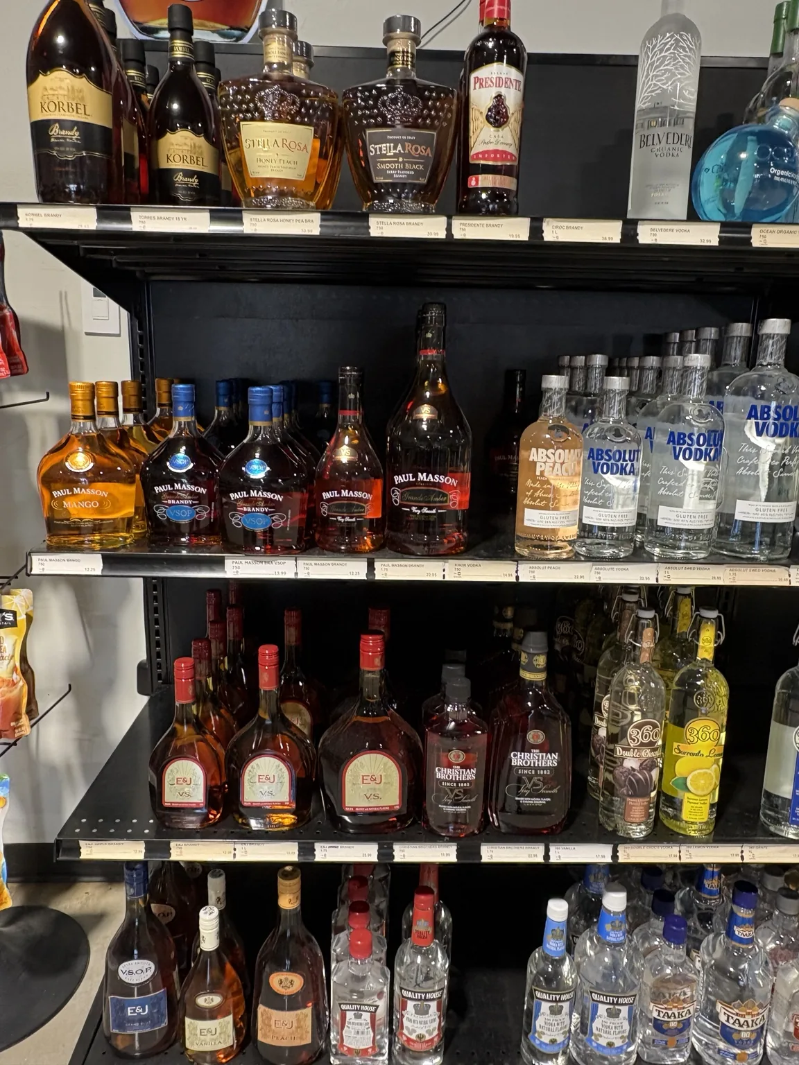 Brandy bottles above Absolut vodka, E&J brandy and flavored vodka at One Stop Liquor in Bethany, Oklahoma