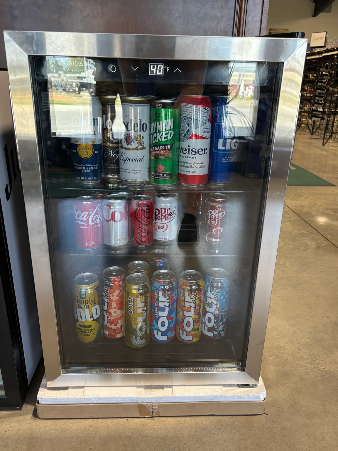 Glass-front cooler stocked with beer, canned cocktails and soft drinks at One Stop Liquor in Bethany, Oklahoma