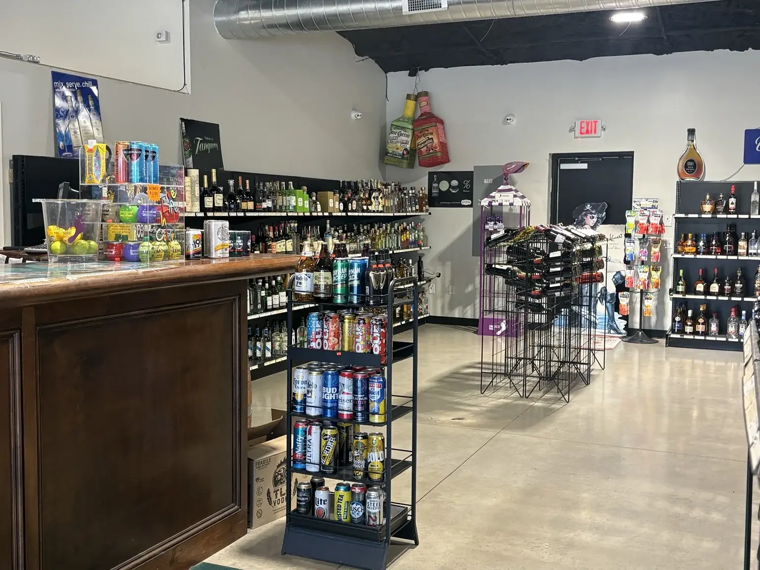 Checkout counter and nearby mixer and drink displays at One Stop Liquor in Bethany, Oklahoma