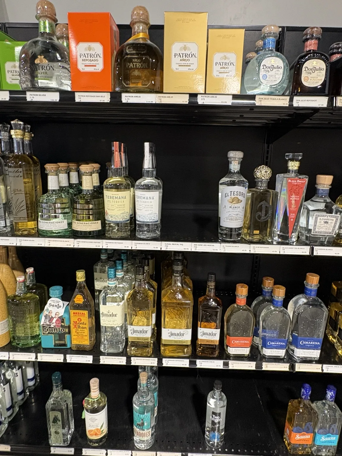 Patrón, Don Julio and Teremana tequila with El Tesoro, el Jimador and Camarena bottles at One Stop Liquor in Bethany, Oklahoma