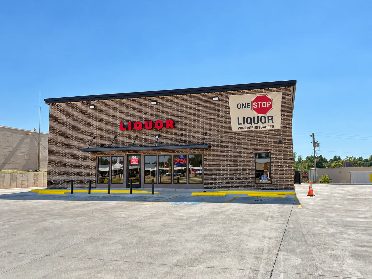 Brick One Stop Liquor storefront with red LIQUOR lettering, store sign and parking area at One Stop Liquor in Bethany, Oklahoma