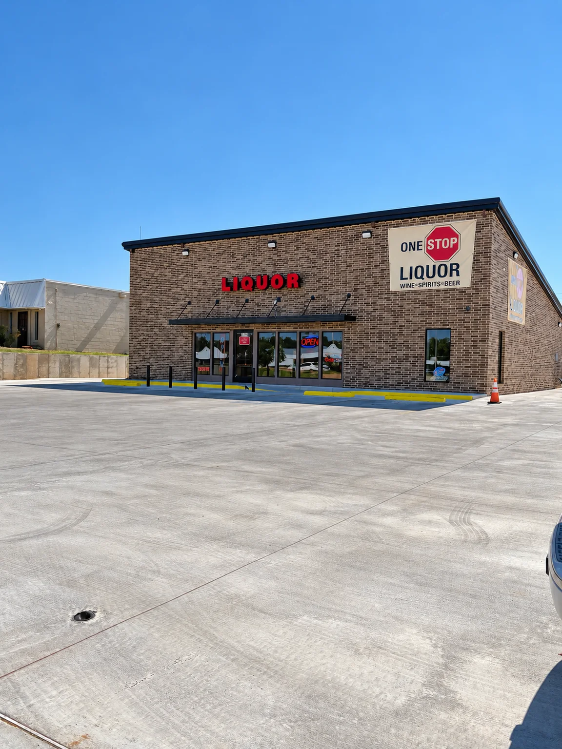One Stop Liquor storefront and entrance viewed across the parking area at One Stop Liquor in Bethany, Oklahoma