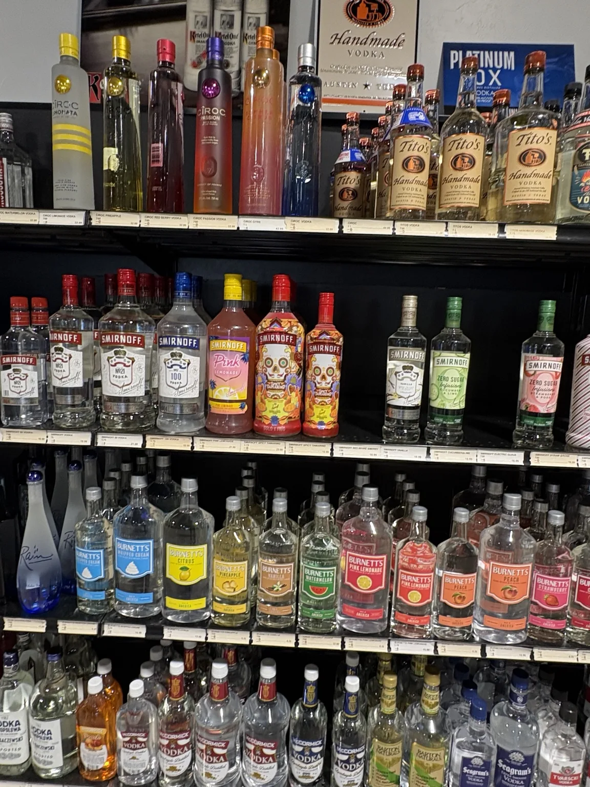 Tito’s Handmade Vodka above Smirnoff, fruit-flavored vodka and Burnett’s bottles at One Stop Liquor in Bethany, Oklahoma