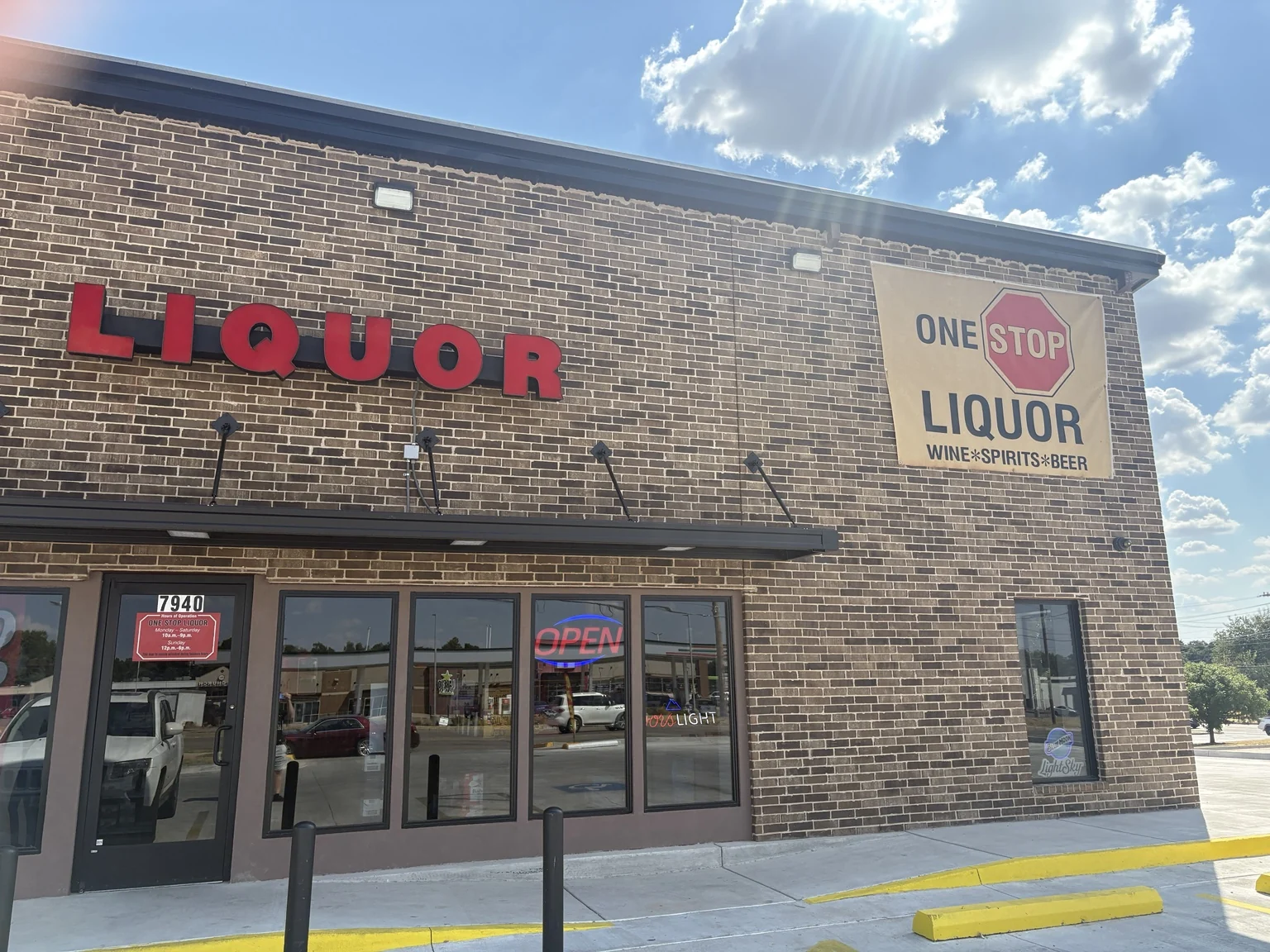 The entrance to One Stop Liquor, with the number 7940 above the door