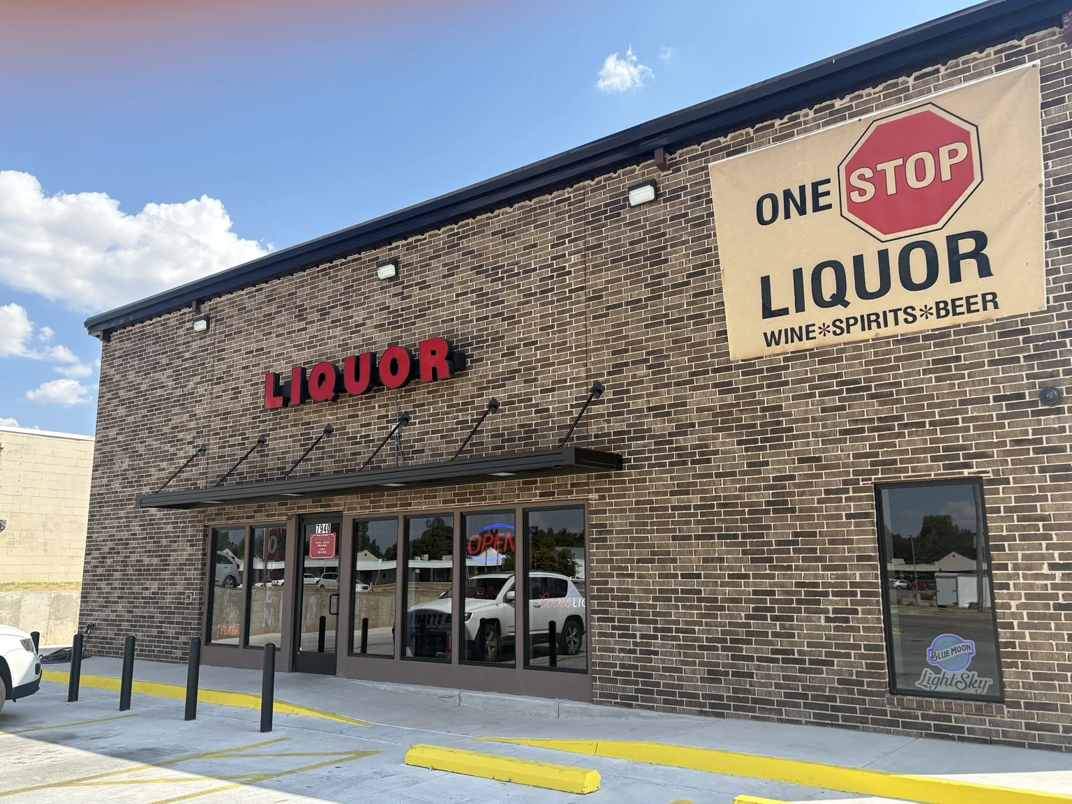 The new One Stop Liquor storefront with its red lettering and wine, spirits and beer sign