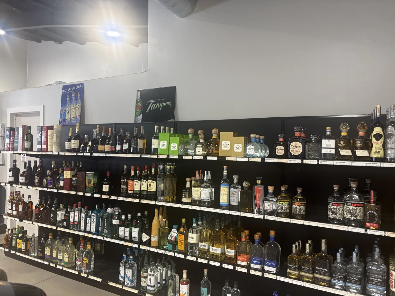 Tequila, Irish whiskey, Scotch and gin along the wall shelves at One Stop Liquor
