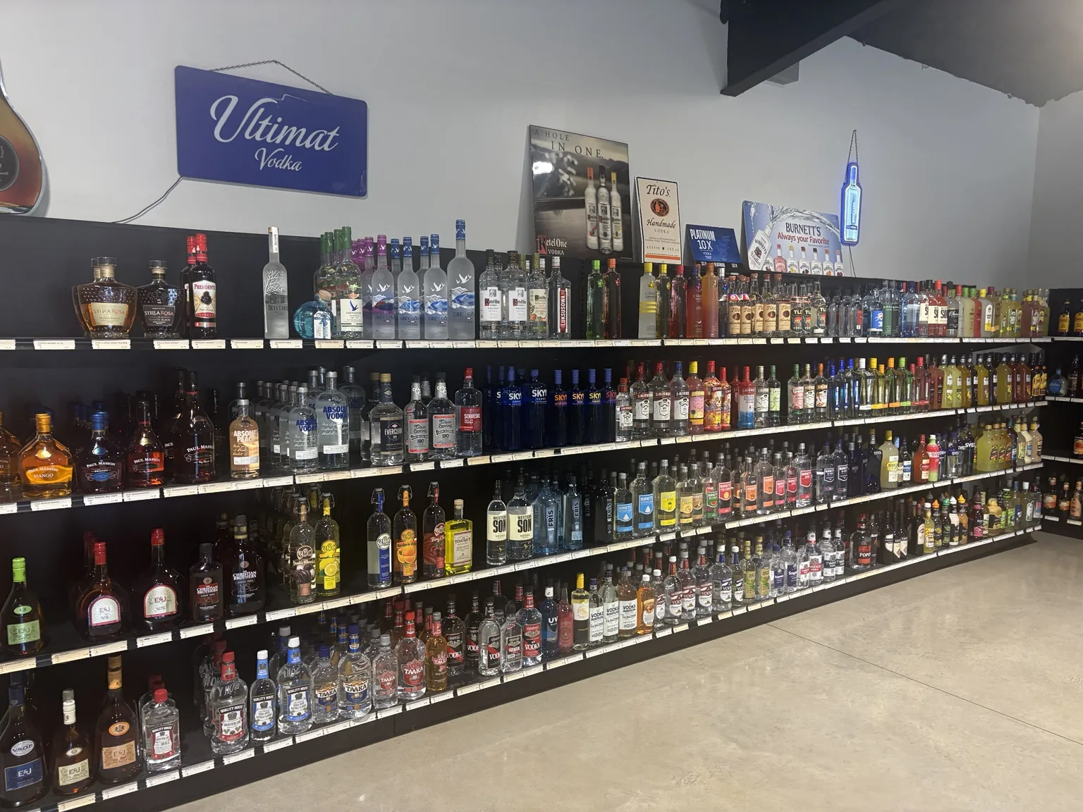 Vodka and brandy shelves with Grey Goose, Ketel One, Tito’s, Absolut and Paul Masson
